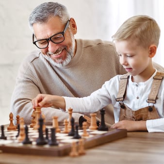 grandfather and grandchild playing chess